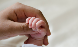 Holding a baby's hand